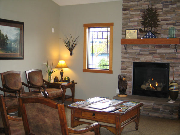 Lobby area with chairs and fireplace at The Center for Esthetic Dentistry in Grants Pass, OR 