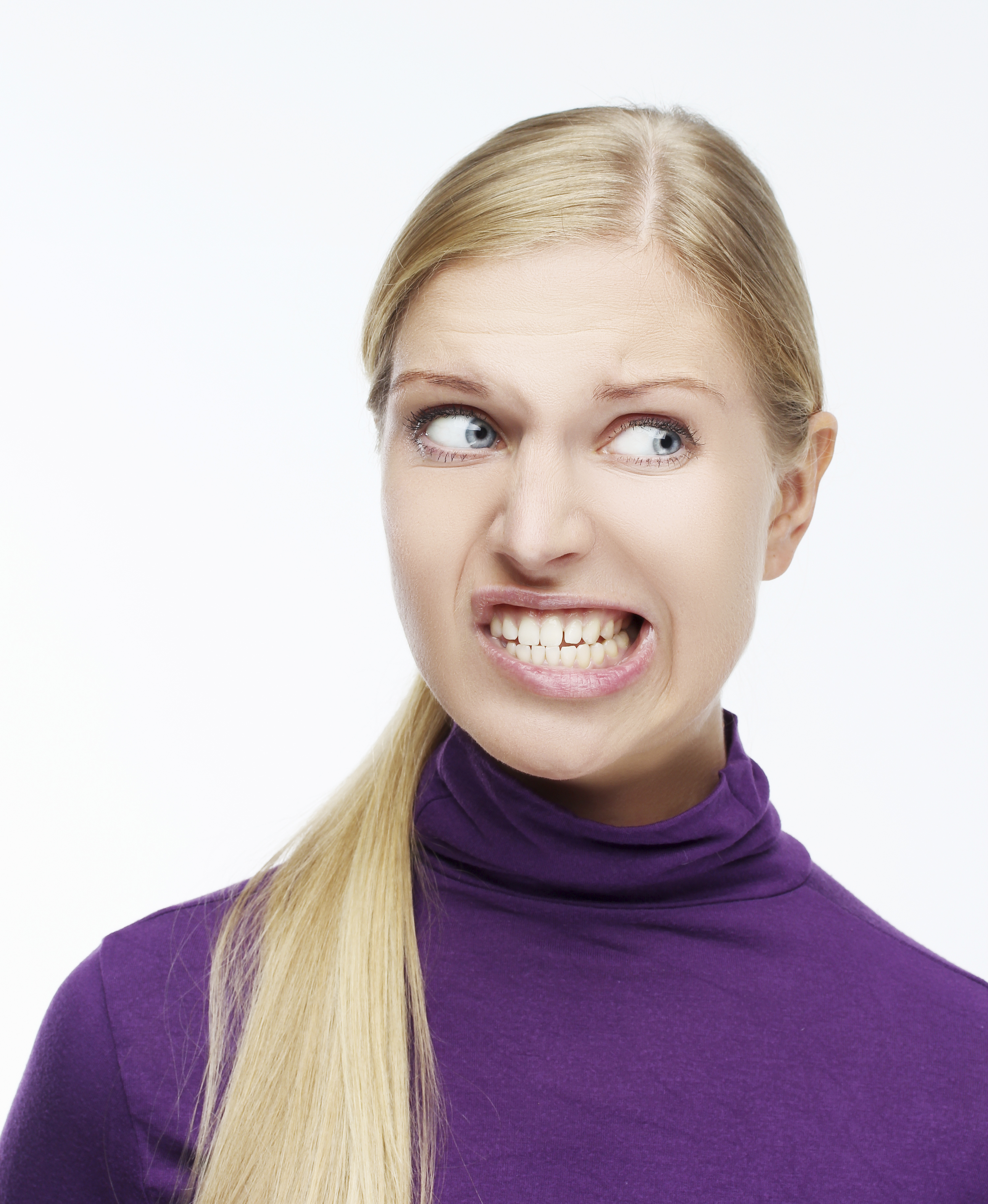 Smiling woman grinding her teeth.