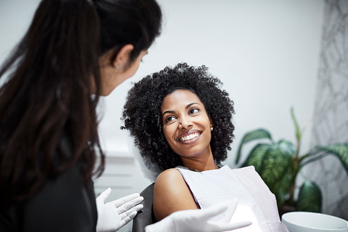 Image of a smiling woman after finding out her dental care is affordable at The Center for Esthetic Dentistry in Grants Pass, OR.