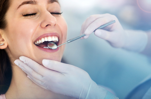 Woman getting dental exam in Grants Pass, OR office.