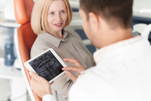 Older woman discussing dental crowns with her dentist at The Center for Esthetic Dentistry in Grants Pass, OR